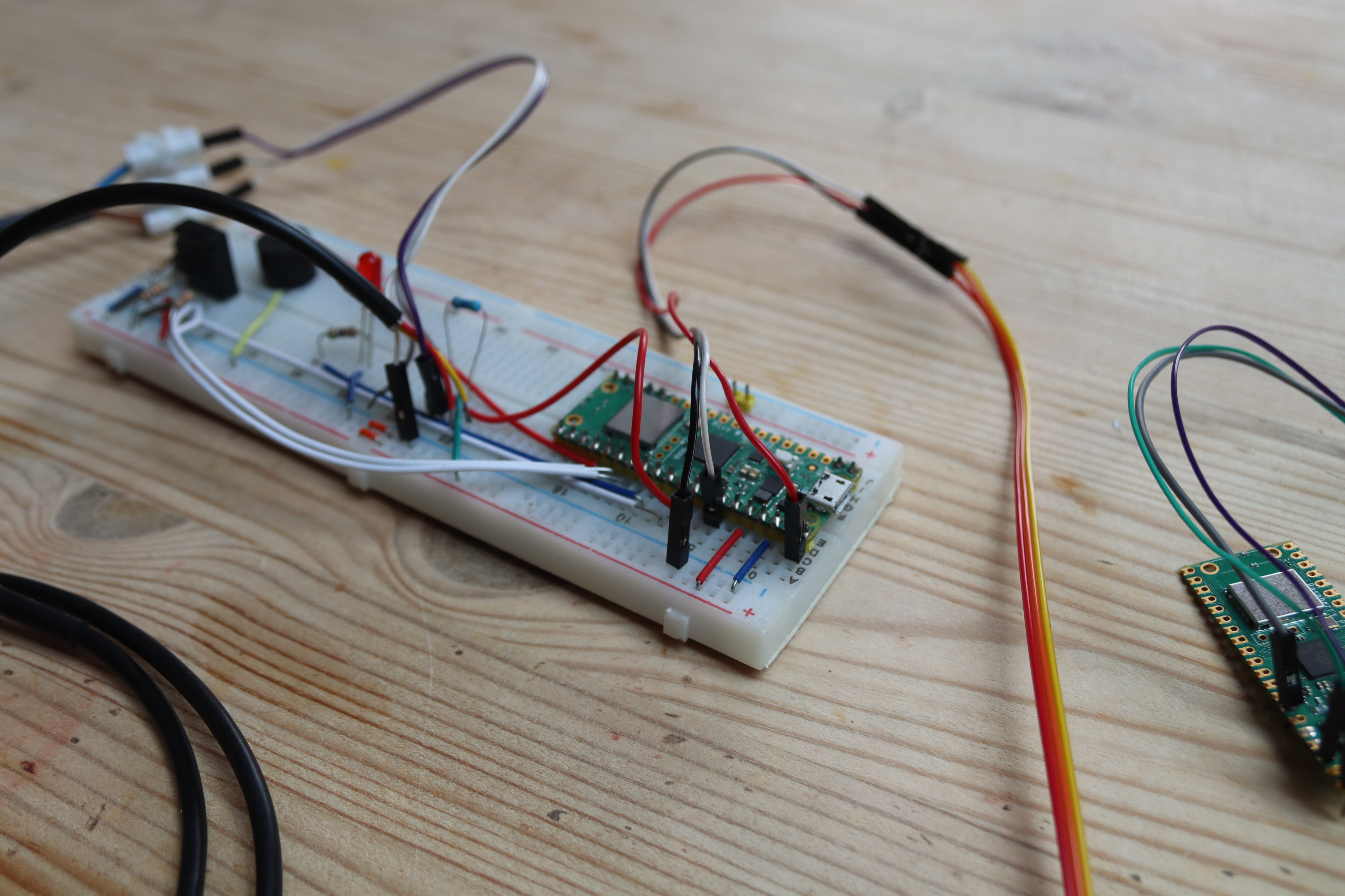 Breadboard with various leads, LEDs and sensors connected to a Pi Pico W